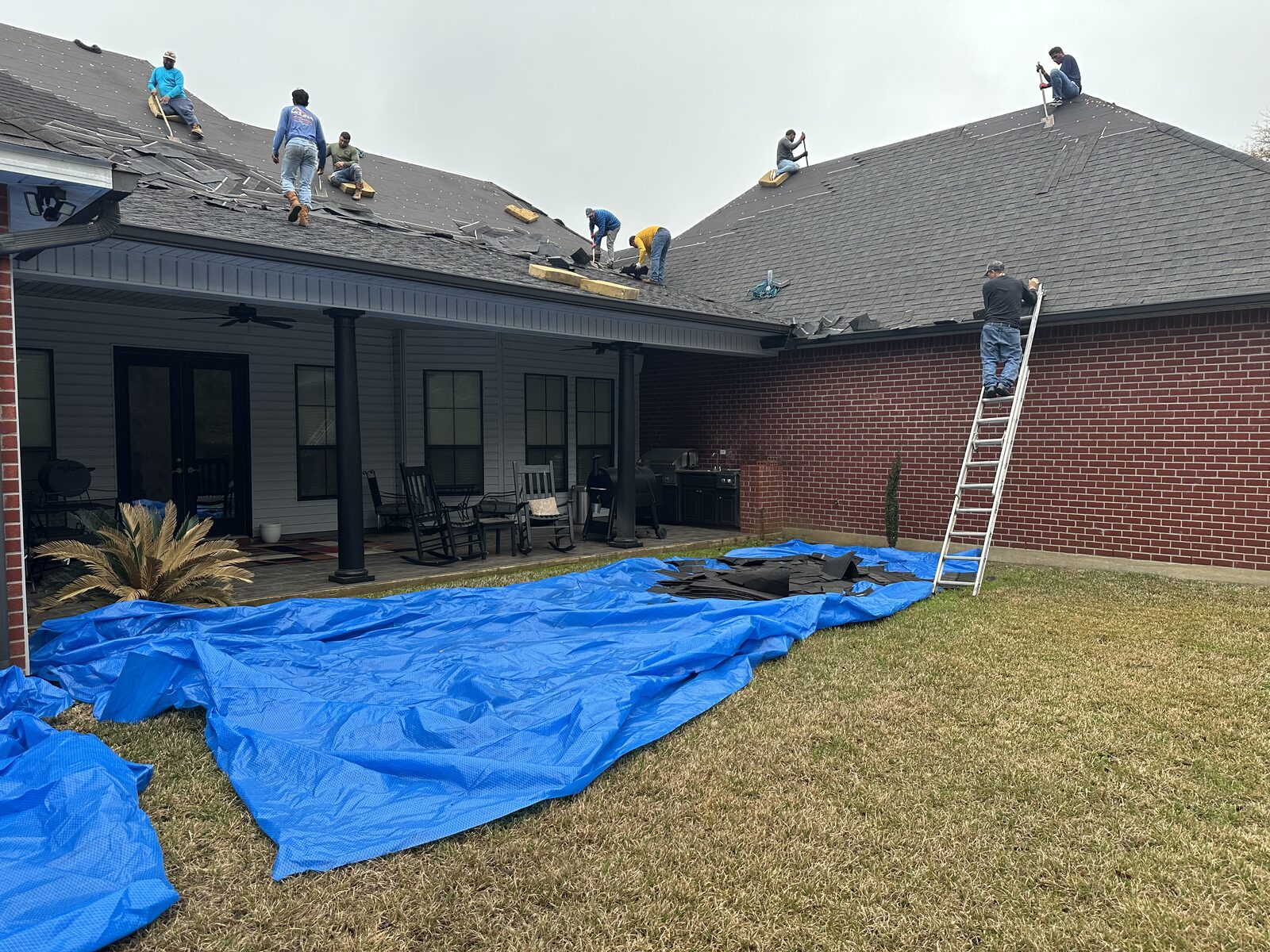 Slopes Roofing crew working on a residential roof in Louisiana