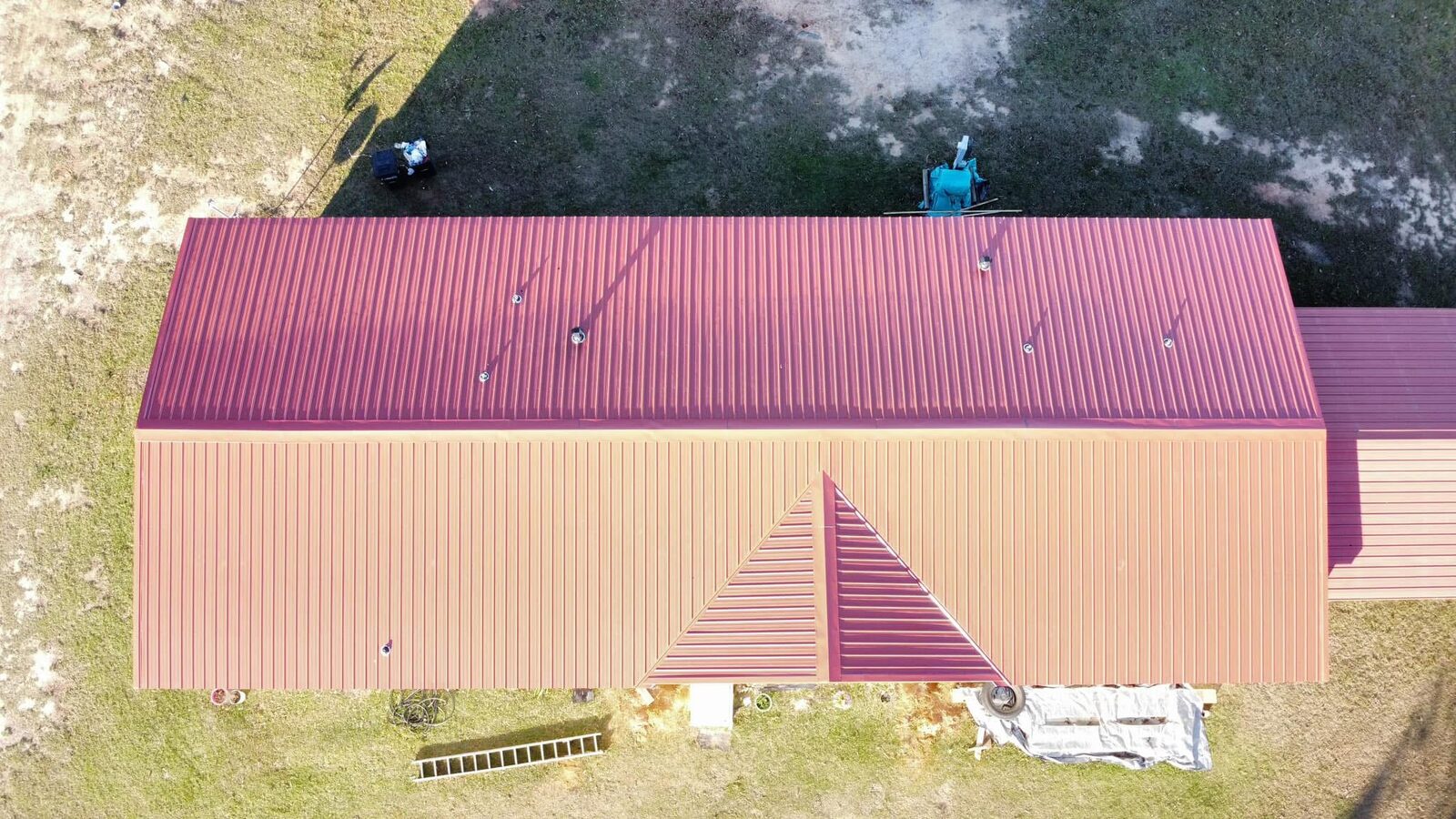 Red low-slope metal roof on a large building in Natchitoches, Louisiana